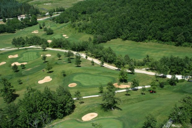 golf course with sand bunkers, trees, rough and water hazards